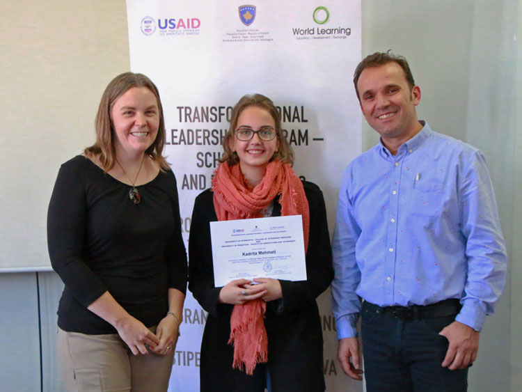 UMN faculty Karin Hamilton and University of Prishtina faculty giving certificate to Prishtina student