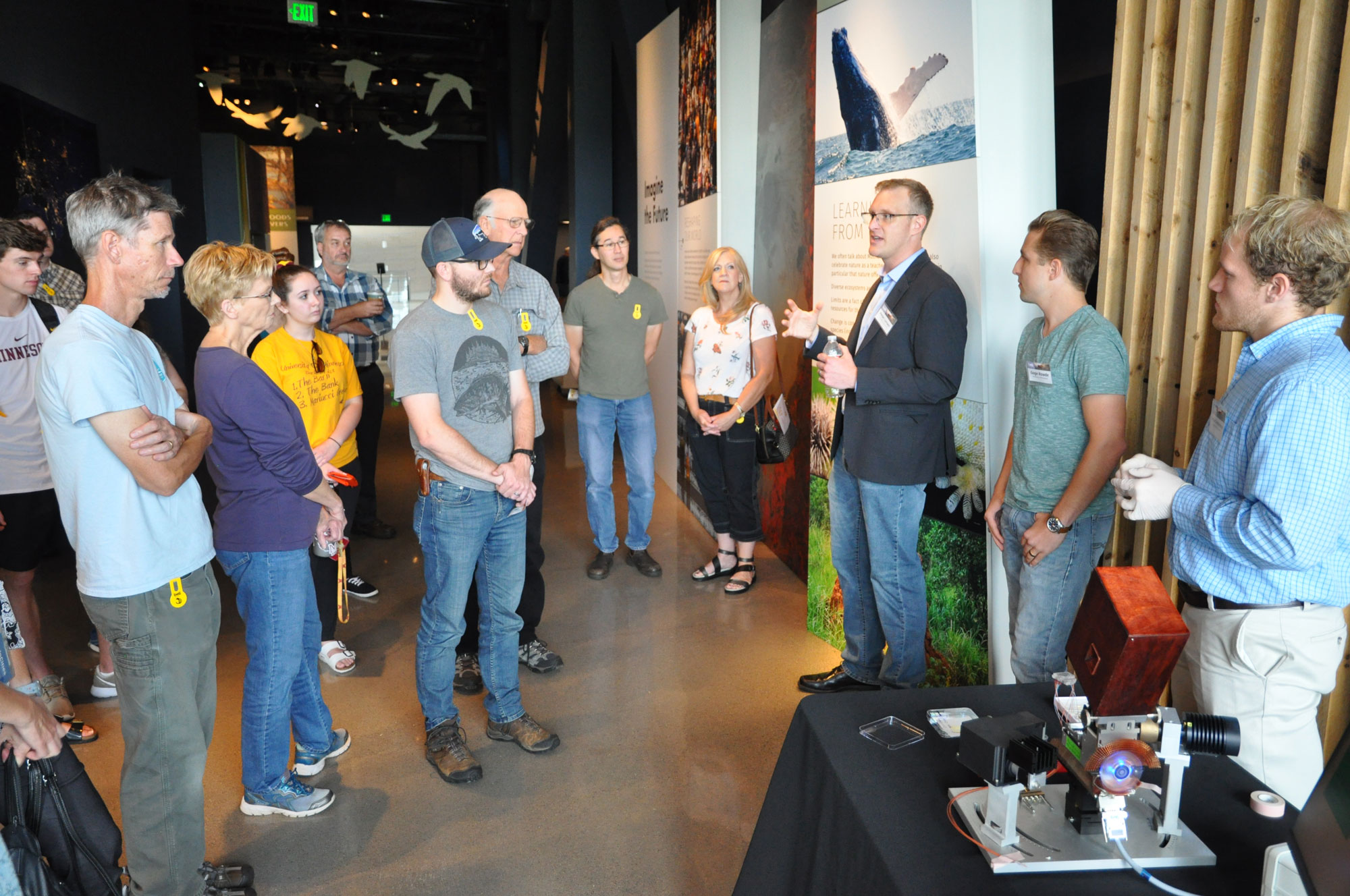 Peter Larsen (third from right) describes CWD diagnostic tools to a crowd at the Bell Museum.