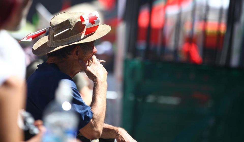 A man wearing a Canada hat at a Cannabis Day party in 2014