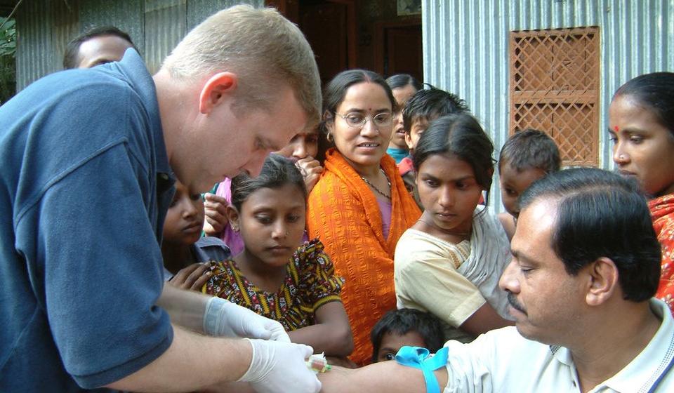 CDC giving vaccinations to a group of people.