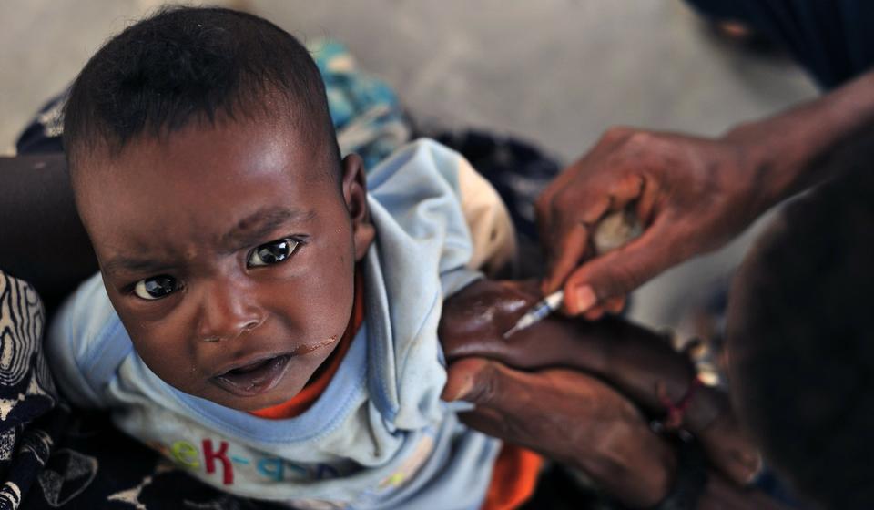 Photo of a small child receiving a vaccination. 
